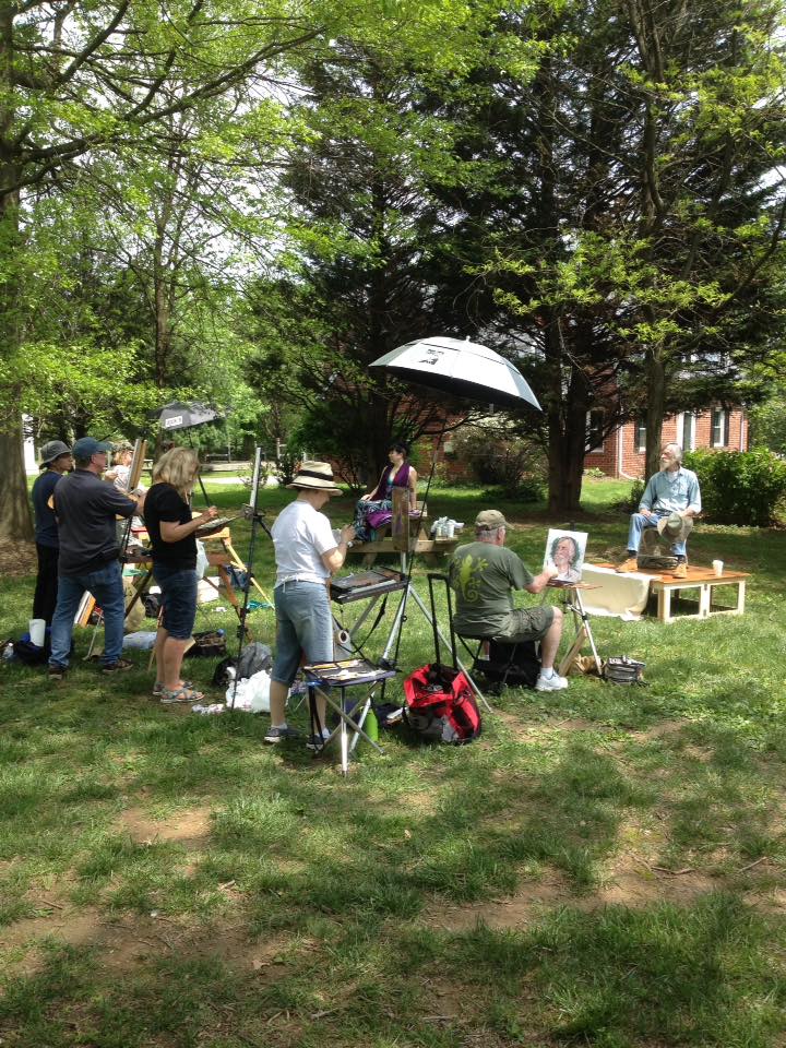 artists painting a model outdoors